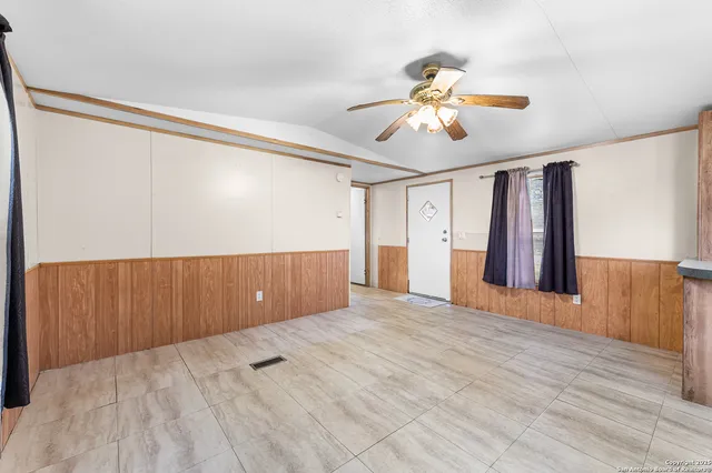 a kitchen with stainless steel appliances kitchen island granite countertop a table chairs sink and cabinets