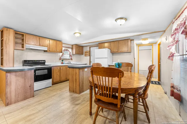 a view of a dining room with furniture and window