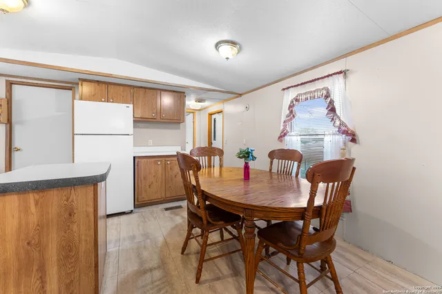 a kitchen with stainless steel appliances granite countertop a stove a sink dishwasher and a refrigerator