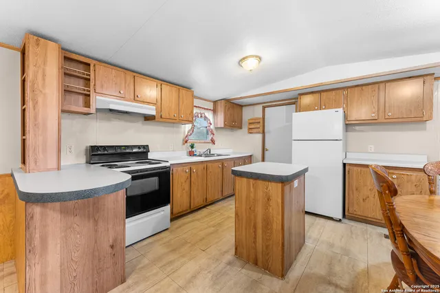 a kitchen that has a sink and a stove
