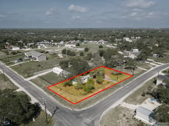 an aerial view of residential houses with outdoor space and swimming pool