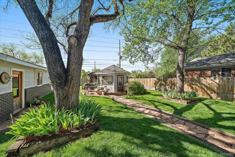 a view of a house with a backyard
