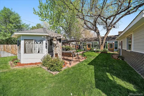 a view of a house with backyard and sitting area