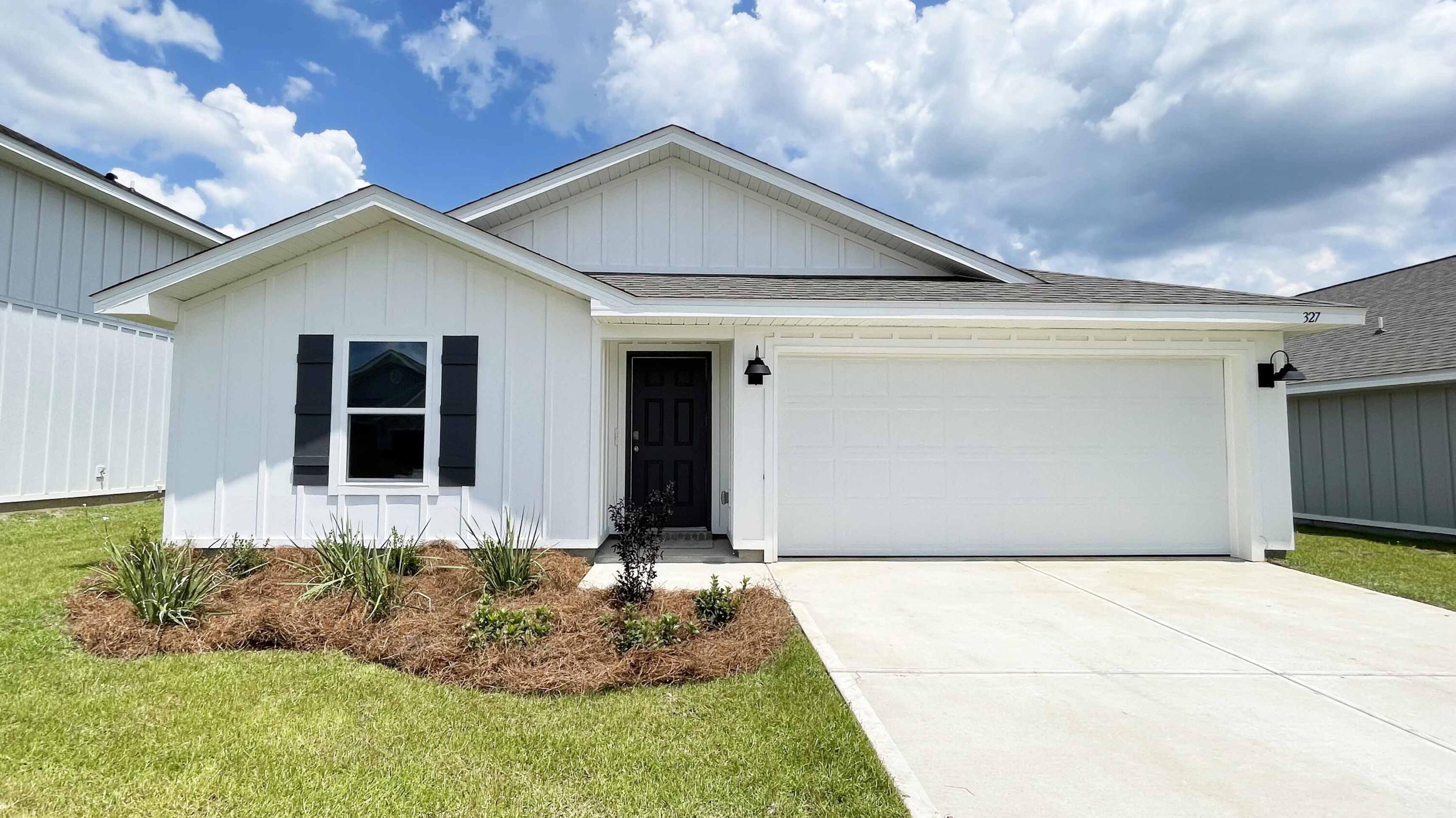327 Flounder Street Crestview, FL 32539 - Photo 2 of 45 a front view of house with garage and yard
