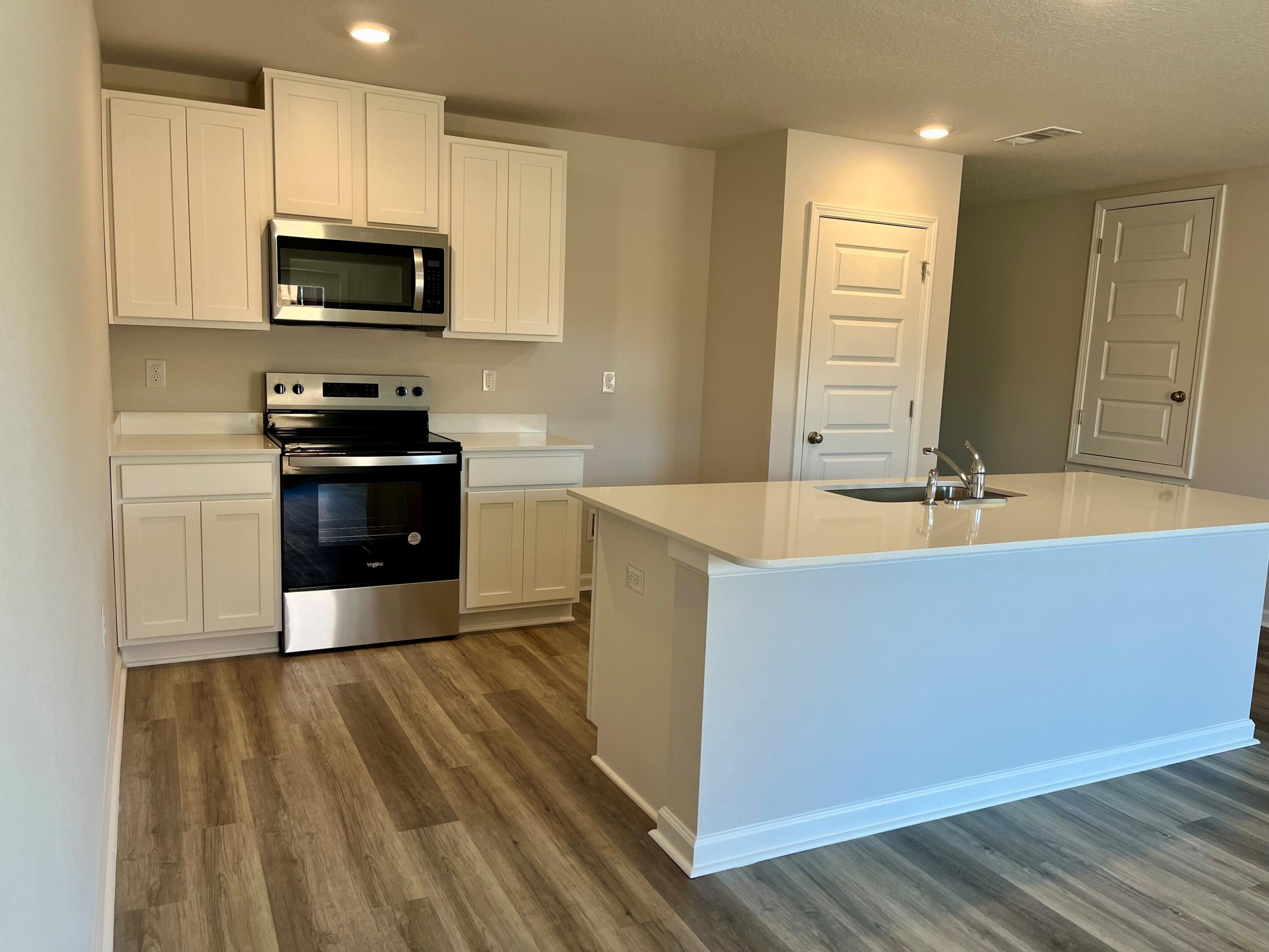 327 Flounder Street Crestview, FL 32539 - Photo 38 of 45 a kitchen with wooden cabinets and black stainless steel appliances