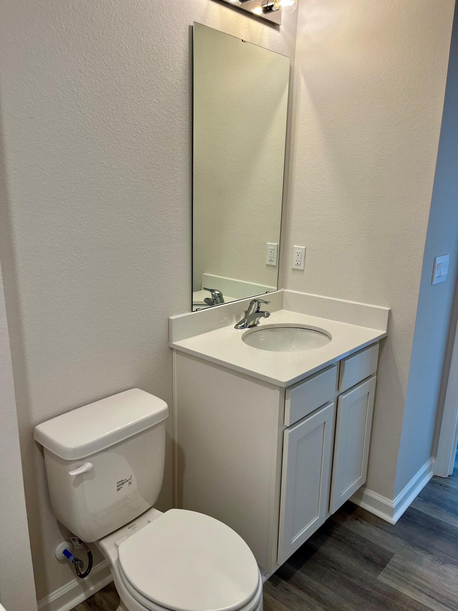 327 Flounder Street Crestview, FL 32539 - Photo 44 of 45 a bathroom with a sink mirror vanity and toilet