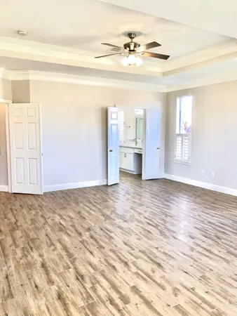 a view of empty room with wooden floor and cabinet