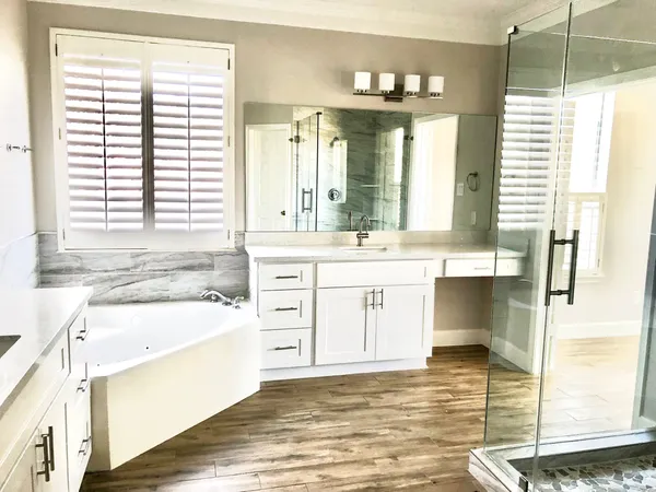 a spacious bathroom with a shower sink and mirror