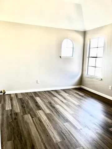 a view of an empty room and wooden floor