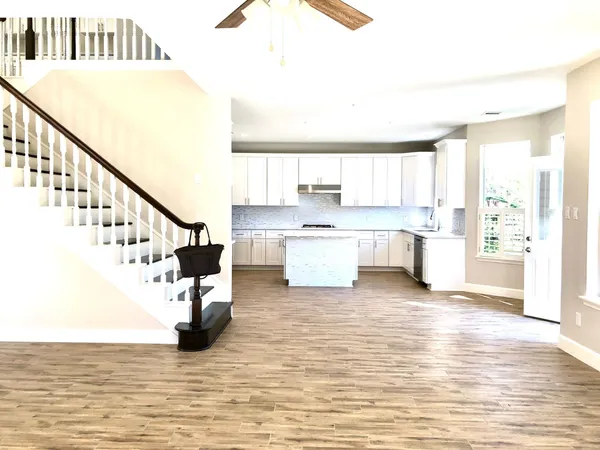 a view of kitchen with wooden floor and electronic appliances