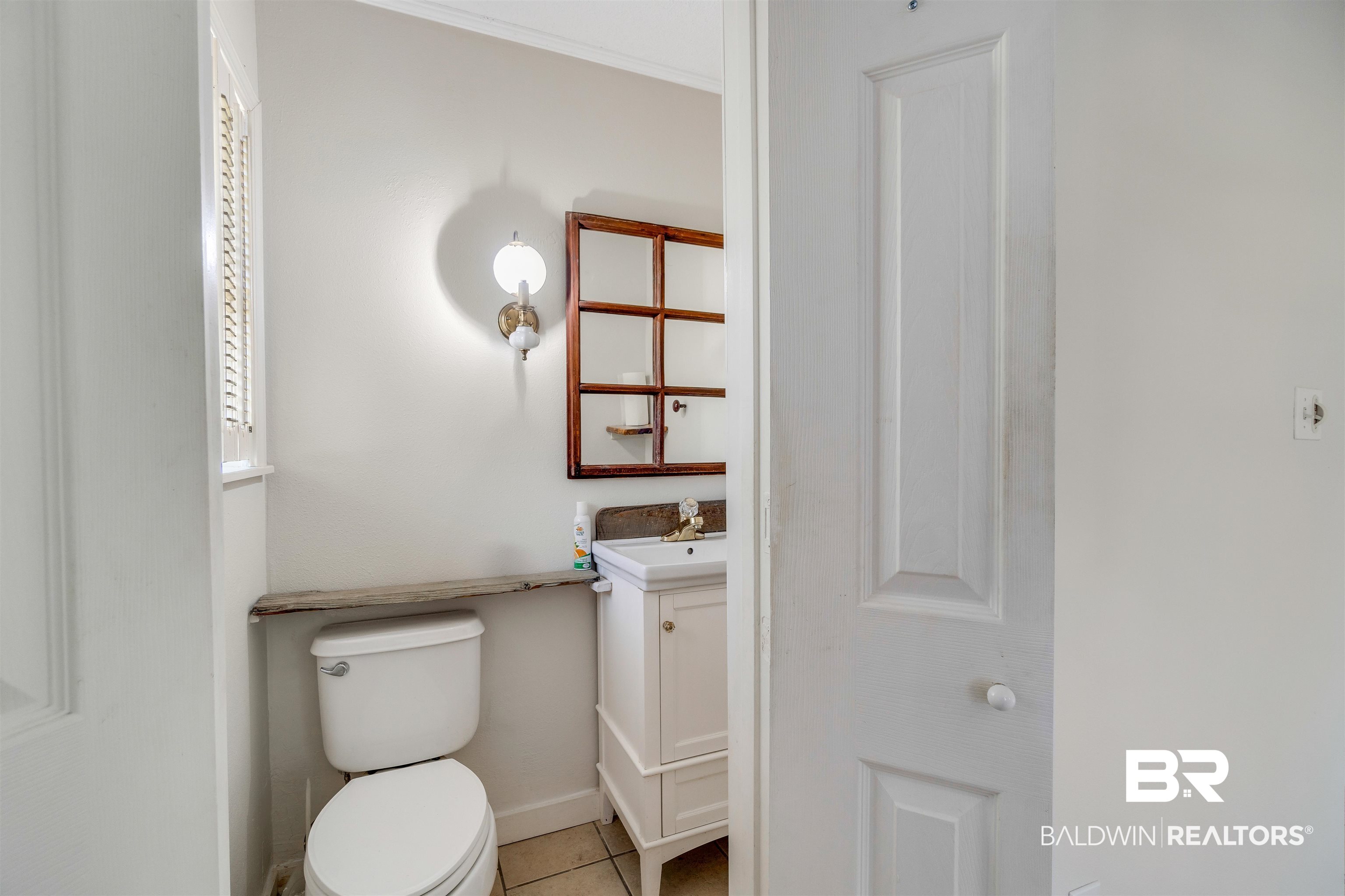 34341 Lost River Road Seminole, AL 36574 - Photo 17 of 36 Half bath featuring vanity, tile patterned flooring, and crown molding