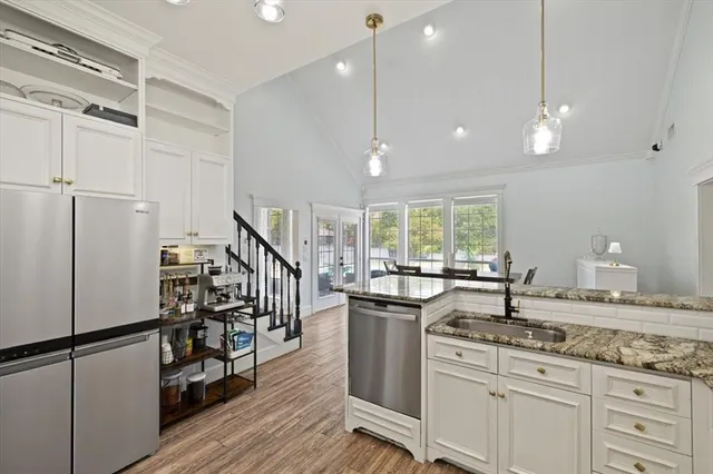 a kitchen with sink cabinets and wooden floor
