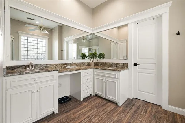 a bathroom with a sink vanity granite and a mirror