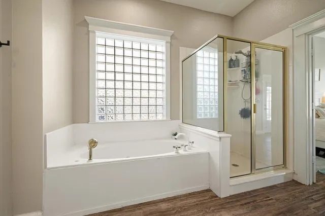 a bathroom with a bathtub and a shower