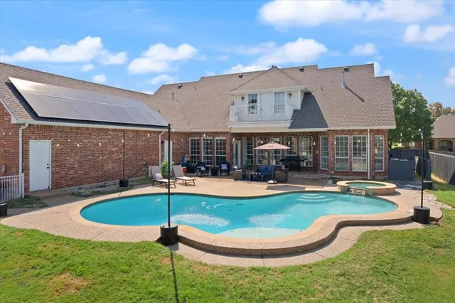 a view of a house with a yard and potted plants