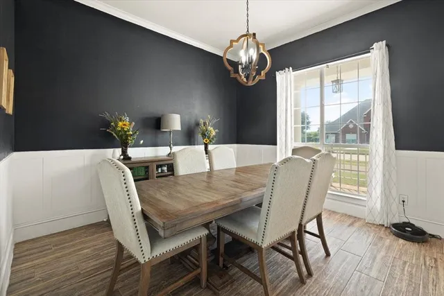 a view of a dining room with furniture wooden floor and chandelier