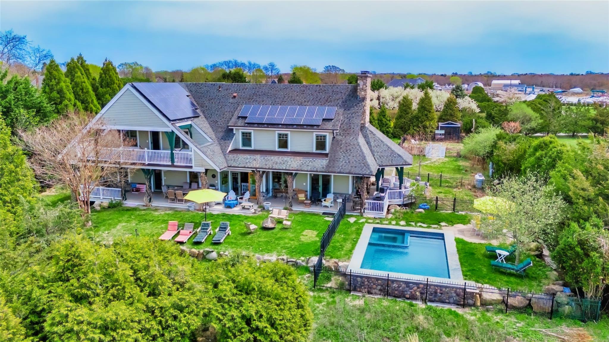 an aerial view of a house with swimming pool garden and mountain view in back