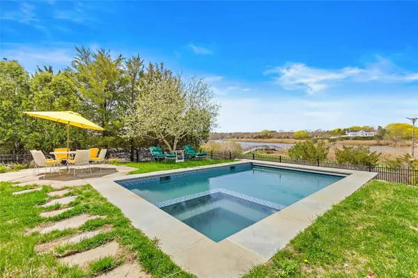 a view of swimming pool with outdoor seating and plants