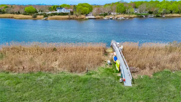an aerial view of a houses with a lake
