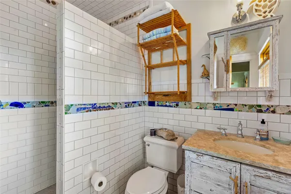 a living room with stainless steel appliances granite countertop furniture wooden floor and view kitchen
