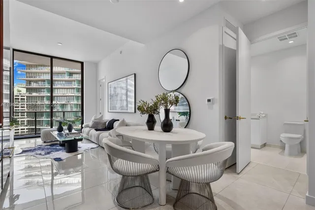 a living room with furniture a large window and a fireplace