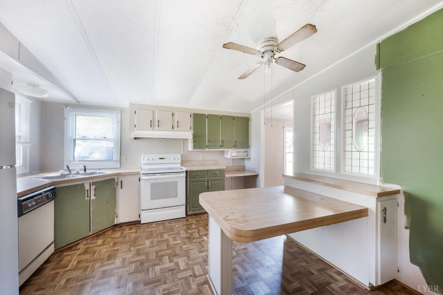 630 Eldon Road Appomattox, VA 24522 - Photo 11 of 37 a kitchen with a stove a sink cabinets and wooden floor