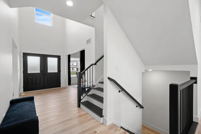 a view of entryway and hall with wooden floor