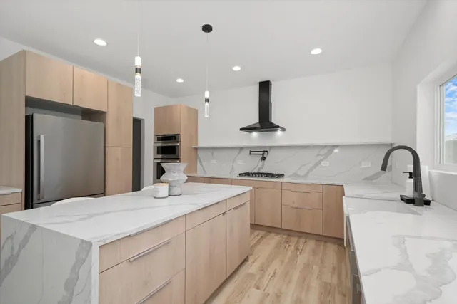 a kitchen with a sink stainless steel appliances and refrigerator