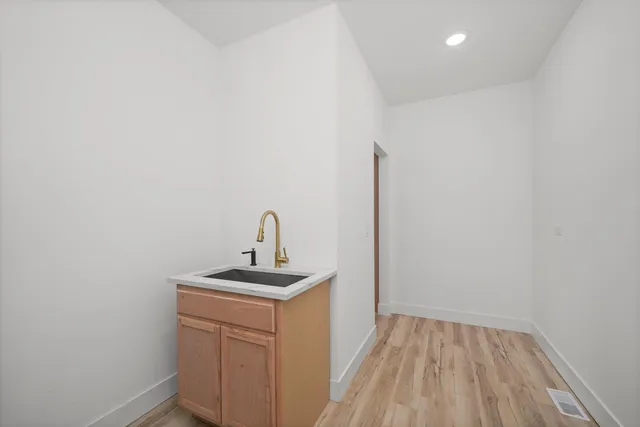 a bathroom with a sink a vanity and a window