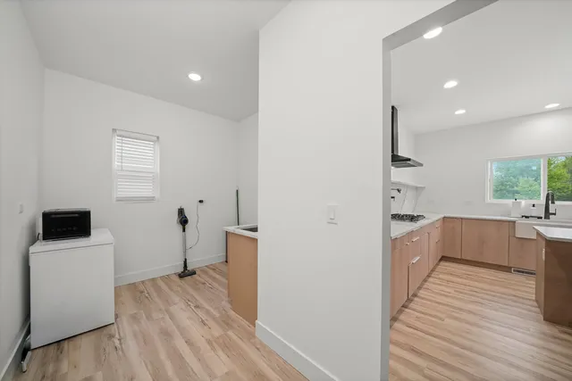 a kitchen with a refrigerator and white cabinets