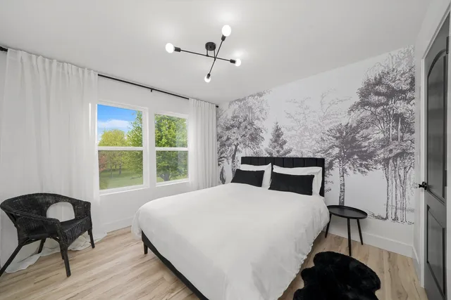 a bedroom with a bed and a chair