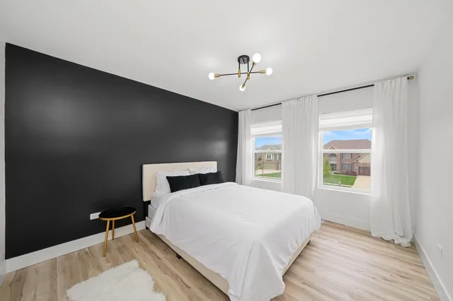 a bedroom with a bed and a window