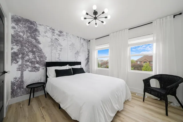 a bedroom with a bed and a chair