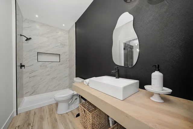 a bathroom with a toilet sink and mirror