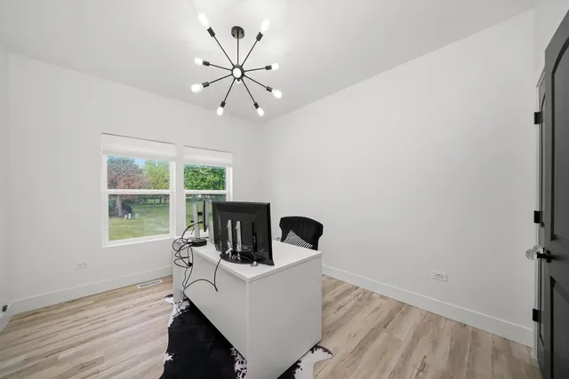 a view of a room with a window and wooden floor