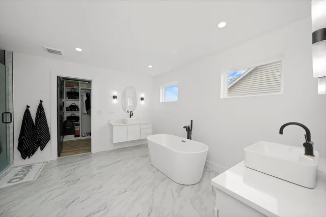 a living room with furniture a window and a flat screen tv