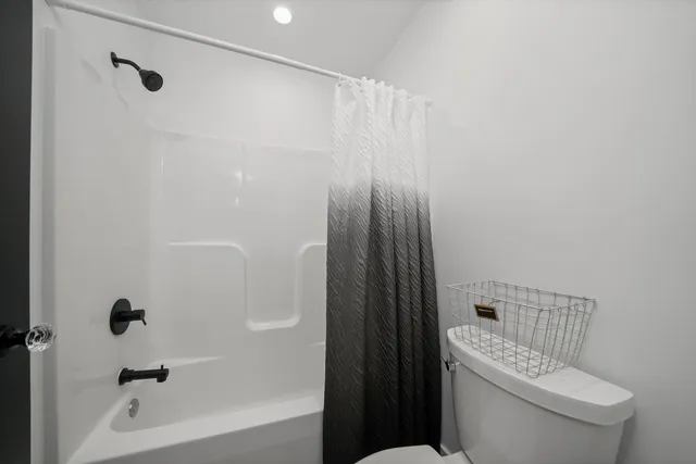 a bathroom with a shower and a toilet