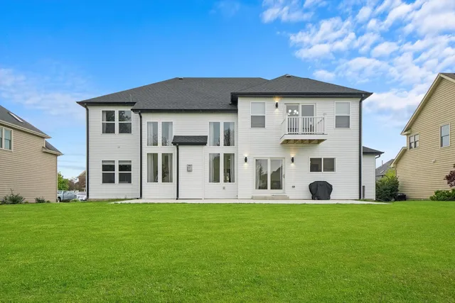 a view of an house with backyard space and swimming pool