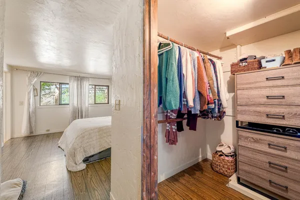 a view of walk in closet with clothes and shoes