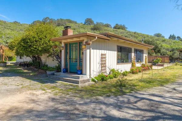 a front view of a house with garden