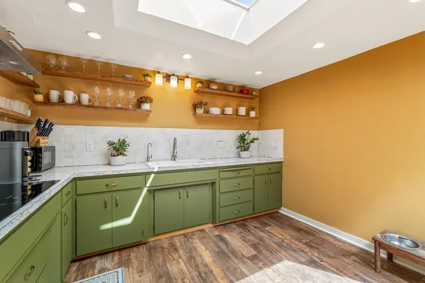 a room with a sink and a mirror