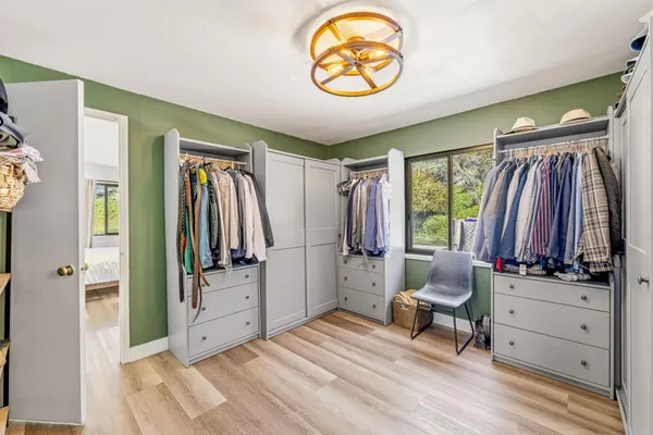 a view of a bedroom with window and furniture