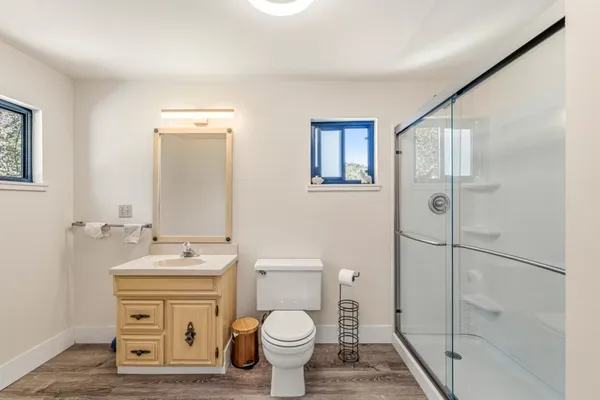 a bathroom with a toilet sink and a mirror