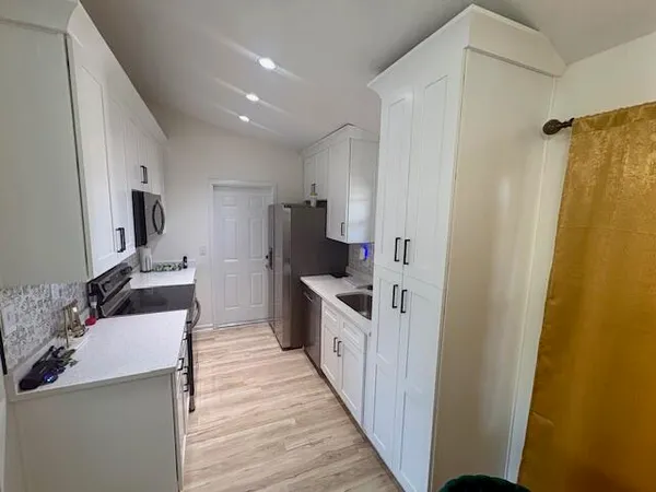 a kitchen with stainless steel appliances a refrigerator and a stove