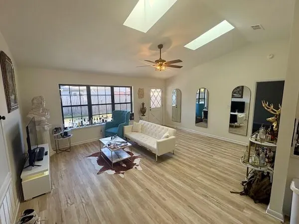 a living room with furniture and a wooden floor