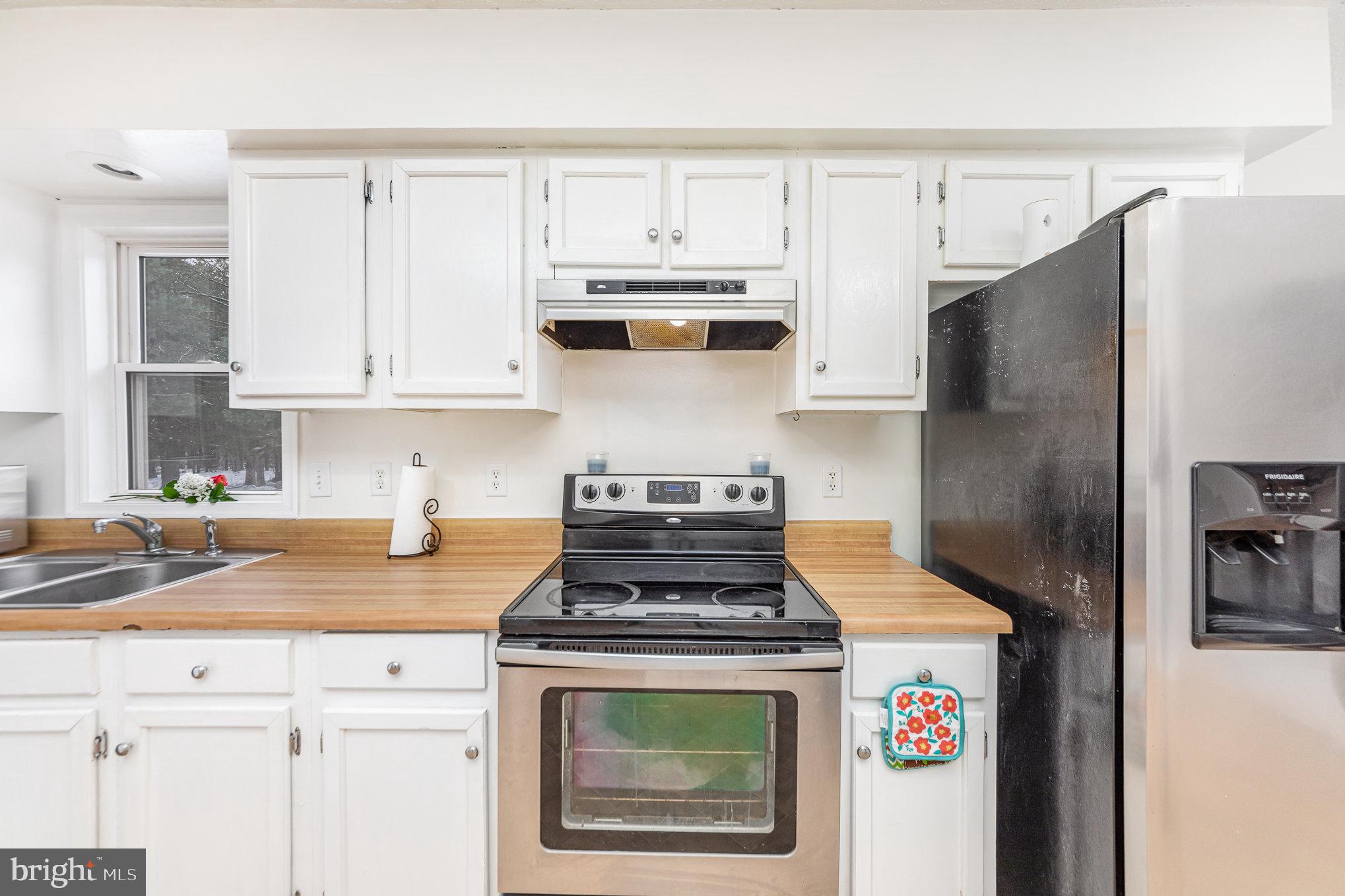 39 Twin Cedars Road Mineral, VA 23117 - Photo 6 of 21 a kitchen with stainless steel appliances granite countertop a stove a refrigerator and a white cabinets