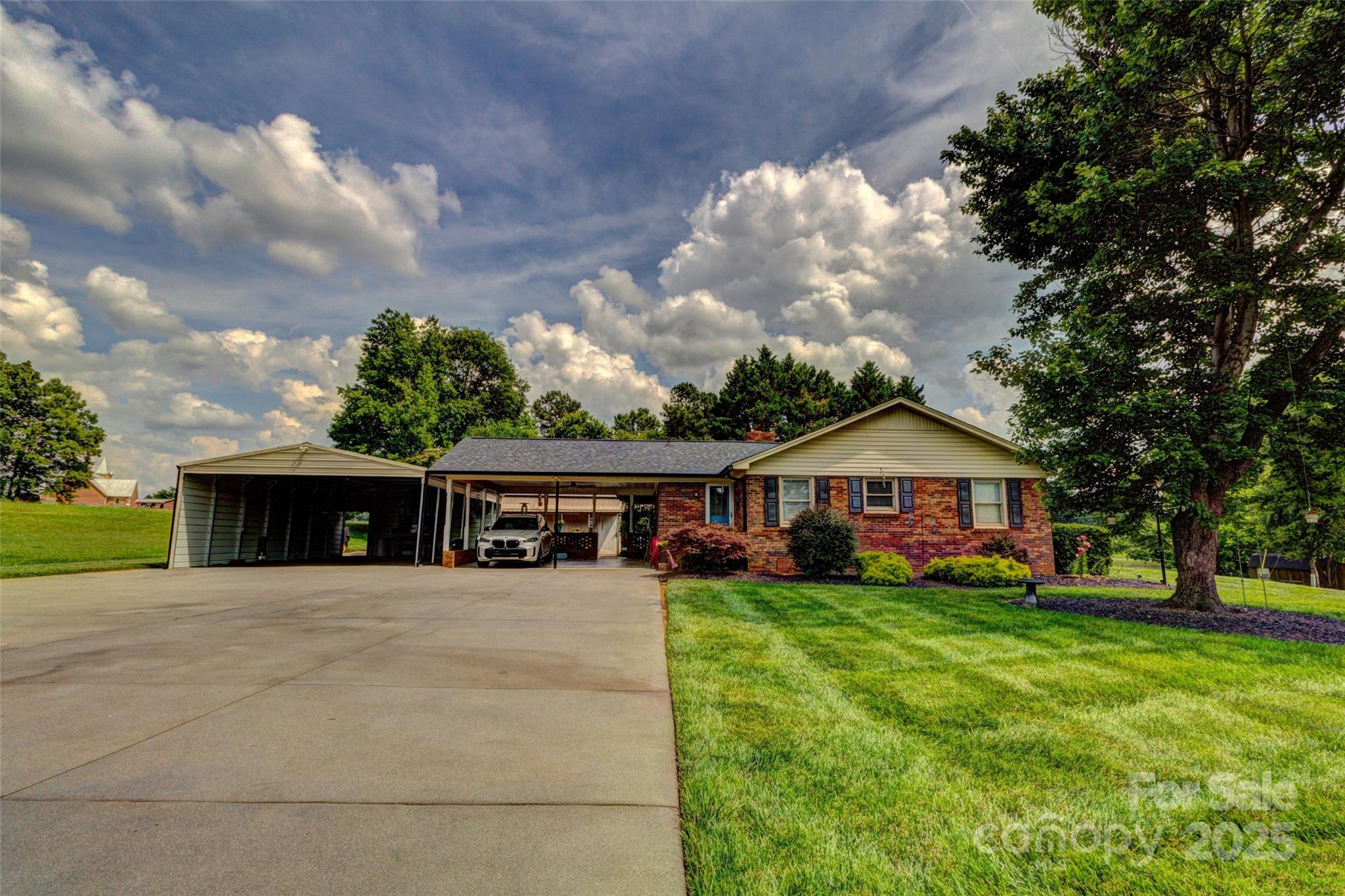 253 Suncrest Road Cherryville, NC 28021 - Photo 12 of 33 a view of a house with a big yard and large trees