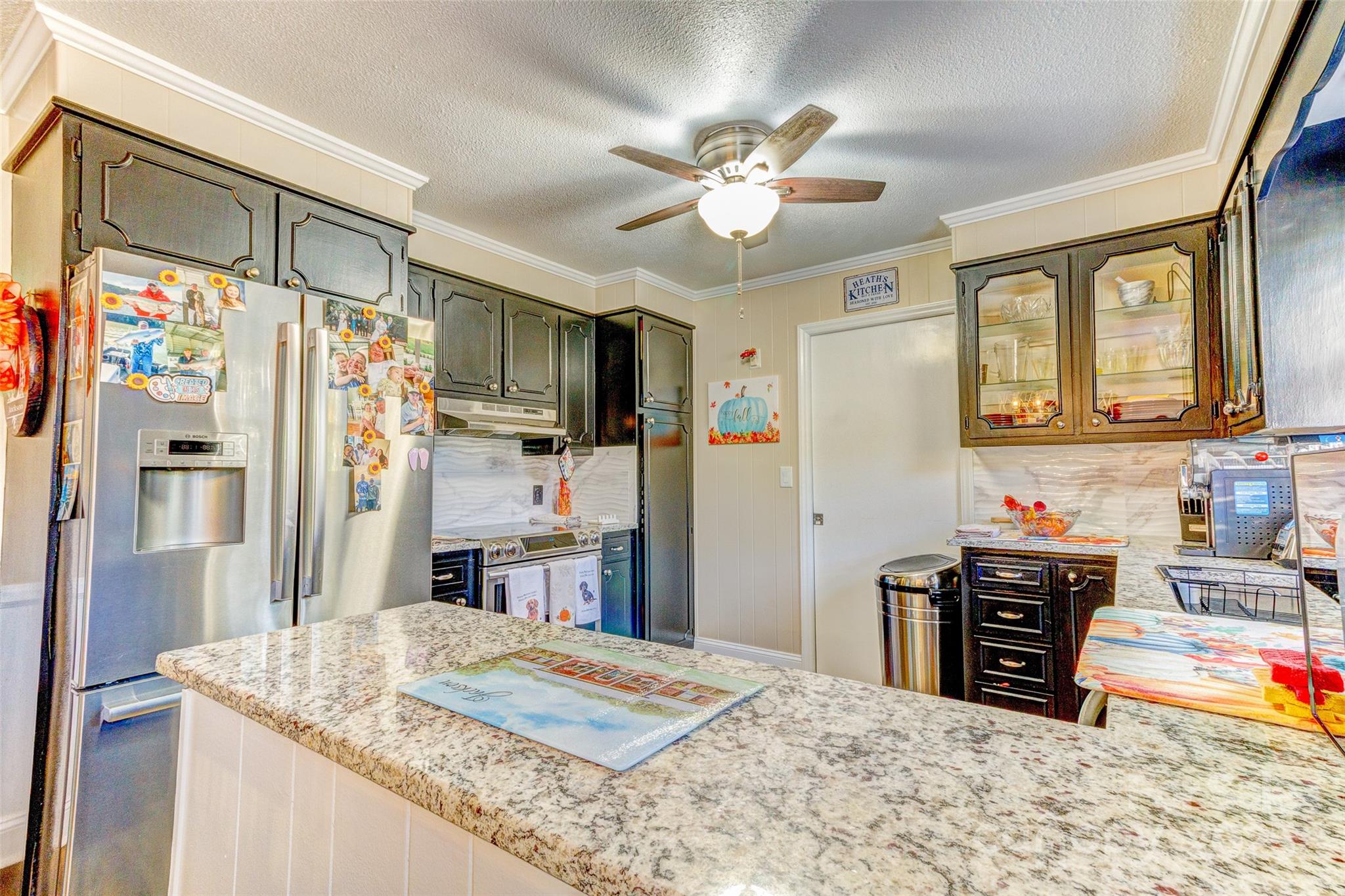 253 Suncrest Road Cherryville, NC 28021 - Photo 19 of 33 a kitchen with stainless steel appliances kitchen island granite countertop a refrigerator and a sink