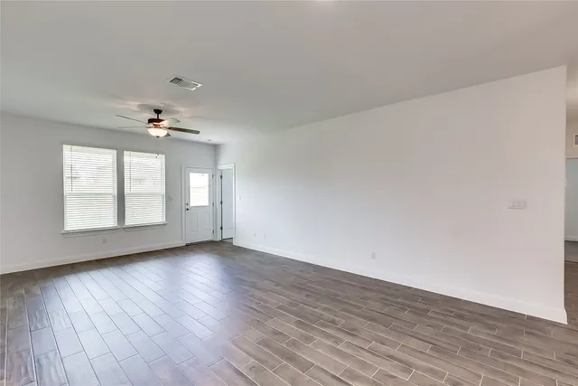 a view of a kitchen with a sink and dishwasher a refrigerator with wooden floor