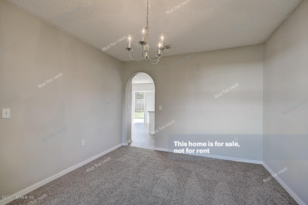 7115 High Bluff Road Jacksonville, FL 32244 - Photo 14 of 45 a view of a chandelier in big room